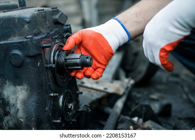 Hands Of Worker Repairing Car Parts In Auto Scrap.