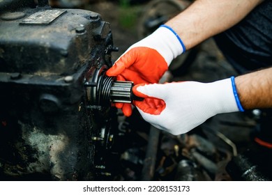 Hands Of Worker Repairing Car Parts In Auto Scrap.