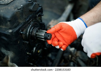 Hands Of Worker Repairing Car Parts In Auto Scrap.