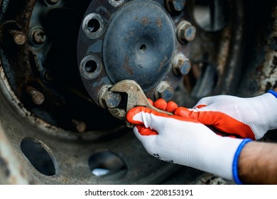 Hands Of Worker Repairing Car Parts In Auto Scrap.