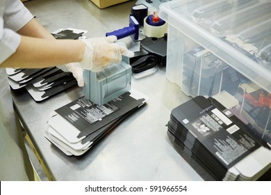 Hands Of Worker Who Marks Cardboard Packages At Factory.