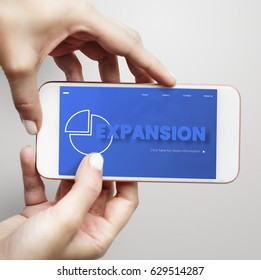 Hands working on digital device network graphic overlay
