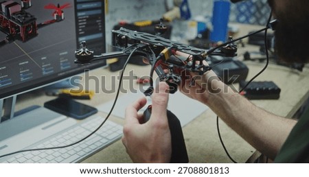 Hands Working on Internal Electronics Drone. Persons Hands Carefully Integrating Internal Electronics and Connecting Antennae on FPV Drone Frame. Concept Precision Assembly and Component Integration.