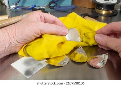 Hands Working on Jewelry with Polishing Cloth and Sterling Silver Shapes Real Jewelry Benches Senior Hands - Powered by Shutterstock