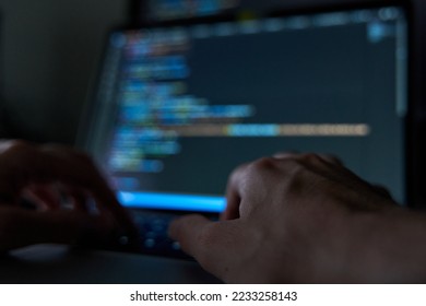 Hands writing code on laptop. Software and web development with javascript and html - Shutterstock ID 2233258143