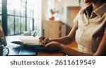 Hands, writing notes and remote work from home by laptop, planning or freelancer with project. Person, writer or editor with notebook, computer and journal for article, review or newsletter in house