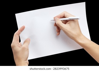 Hands writing on empty paper with white pen, isolated on black background