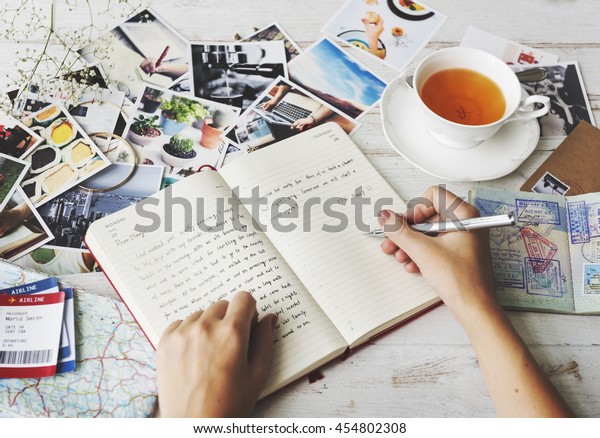 Hands Writing Travel
Journal Tea Concept