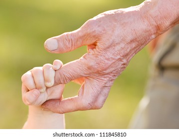 hands of young child and old man