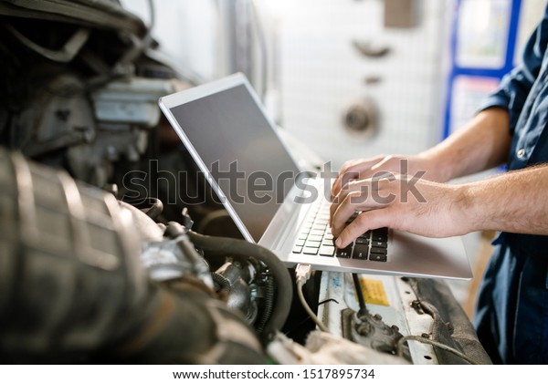 Hands of young contemporary worker of technical\
service touching keys of laptop keypad while looking for online\
instructions or data