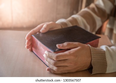Hands of young man with bible. christian concept. - Shutterstock ID 1303567507