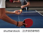 Hands of young man serving ping pong ball with topspin