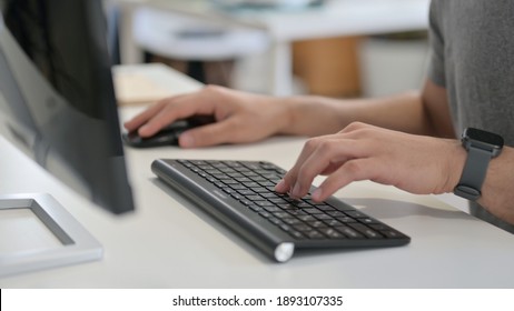 Hands of Young Man Using Mouse and Keyboard, Close Up 