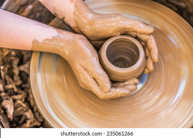 Hands of young potter, was produced on range of pot. - Shutterstock ID 235061266