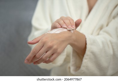 Hands Of Young Woman Applies Hand Skincare Cream. Woman Model  With Body Cream Jar In Hands. Winter Skin Care And Wellness Concept. Selective Focus, Copy Space.