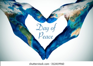 the hands of a young woman forming a heart patterned with a world map (furnished by NASA) and the text day of peace, slight vignette added - Shutterstock ID 312419960
