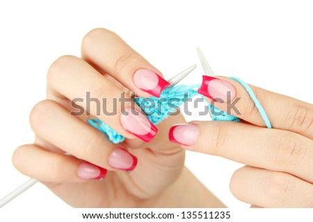 Hands of young woman knitting with blue wool, isolated on white