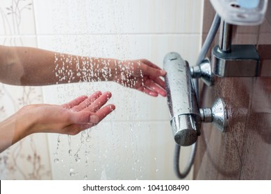 Hands Of A Young Woman Taking A Hot Shower At Home