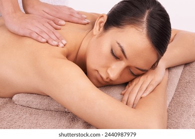 Hands, zen and woman with back massage at spa for wellness, self care and grooming treatment in studio. Skin, calm and female person with masseuse for body routine on table by white background. - Powered by Shutterstock