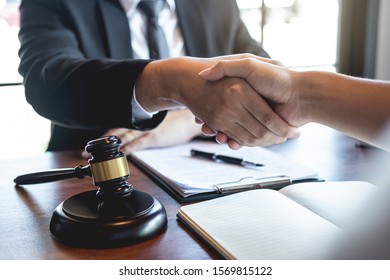 Handshake after good deal negotiation cooperation, Professional male lawyer or counselor and client meeting, working with legal case document contract in office, law and justice, attorney, lawsuit. - Shutterstock ID 1569815122
