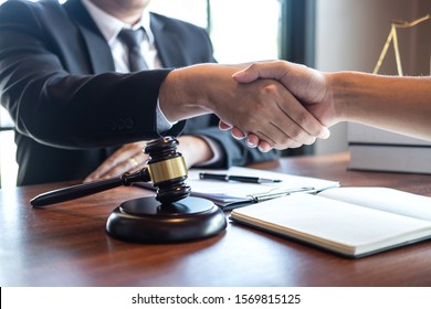 Handshake after good deal negotiation cooperation, Professional male lawyer or counselor and client meeting, working with legal case document contract in office, law and justice, attorney, lawsuit. - Shutterstock ID 1569815125