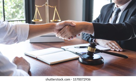 Handshake after good deal negotiation cooperation, Professional male lawyer or counselor and client meeting, working with legal case document contract in office, law and justice, attorney, lawsuit. - Shutterstock ID 1570072936