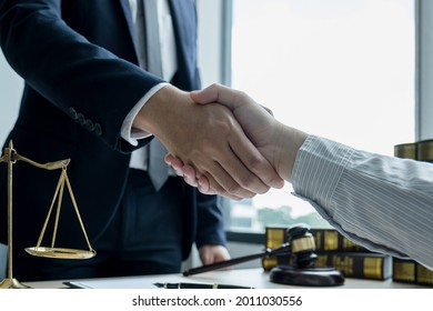 Handshake After Lawyer  Providing Legal Consult Business Dispute Service To The Man At The Office With Justice Scale And Gavel Hammer.