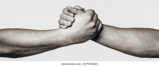 Handshake, arms, friendship. Friendly handshake, friends greeting, teamwork friendship. Rescue, helping gesture or hands. Strong hold. Close-up. Two hands, helping hand of a friend. Black and white.