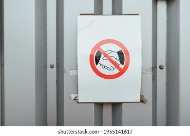 the handshake ban sign. a warning sign hangs on the wall. you can not shake hands because of the risk of contracting the virus during the epidemic - Shutterstock ID 1955141617