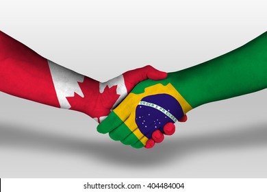 Handshake between brazil and canada flags painted on hands, illustration with clipping path.