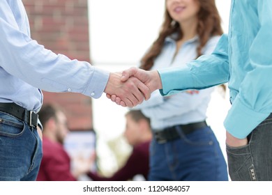 Handshake between businesspeople in a modern office. - Shutterstock ID 1120484057