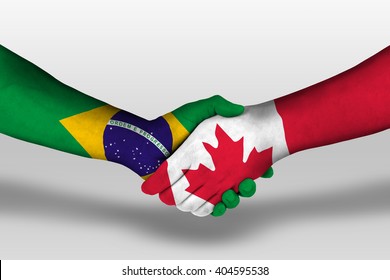 Handshake between canada and brazil flags painted on hands, illustration with clipping path.