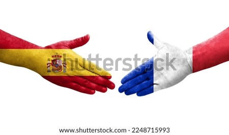 Handshake between France and Spain flags painted on hands, isolated transparent image.