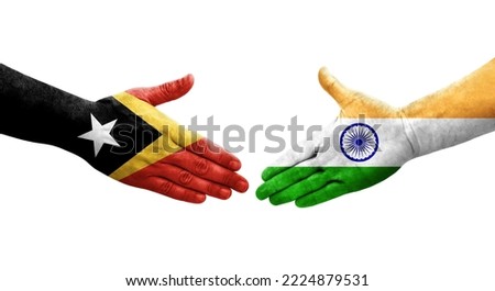 Handshake between India and Timor Leste flags painted on hands, isolated transparent image.