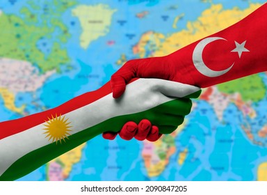 Handshake between Kurdistan and Turkey flags painted on hands.With background of world map