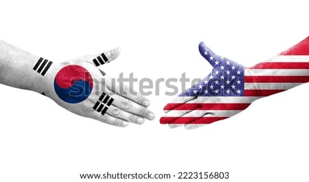 Handshake between South Korea and USA flags painted on hands, isolated transparent image.