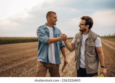 Handshake between two men in the field - Powered by Shutterstock