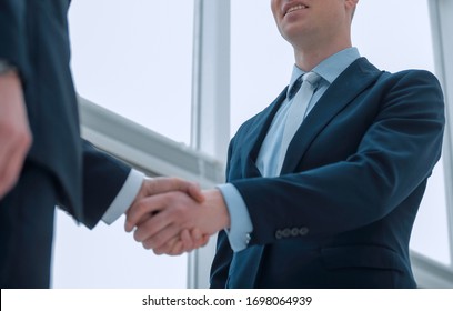 handshake of business partners after a favorable trade deal - Shutterstock ID 1698064939