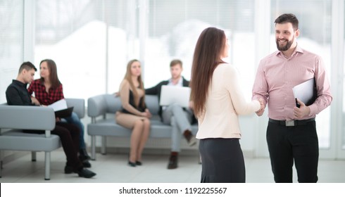 Handshake Of A Businessman And Business Woman In The Lobby Of The Bank