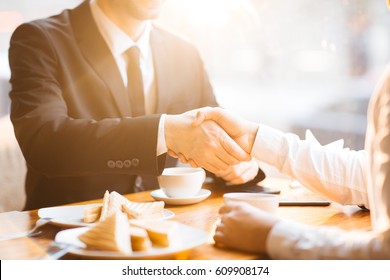 Handshake of businessmen during lunch break