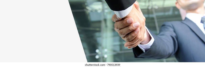 Handshake of businessmen, panoramic banner background with copy space