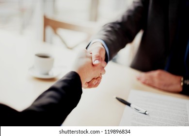 Handshake Closeup Of Businesswoman And Businessman.