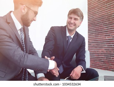 Handshake of colleagues before the meeting - Shutterstock ID 1034532634