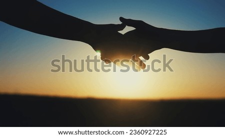 handshake farmers silhouette. agriculture business concept. close-up farmers hands silhouette shaking hands sun silhouette making contract agreement. farmers negotiations in agriculture business