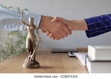 handshake of a female lawyer at a meeting with a male client in the office of the law office, legal advice online. resolution of disputes of the family code during divorce and division of property - Shutterstock ID 2130471254