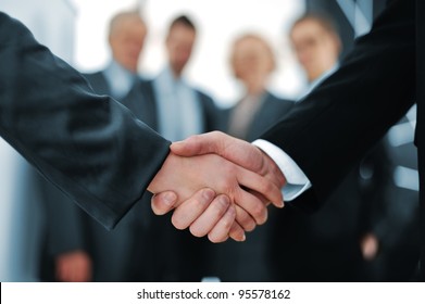 Handshake in front of business people