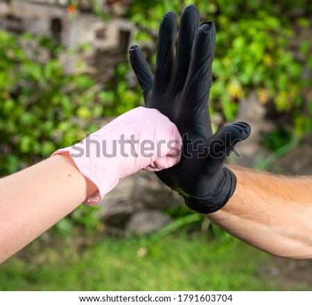 Handshake, greeting in medical protective gloves. Protection against coronavirus