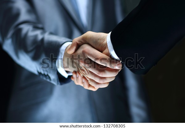 Handshake - Hand
holding on black
background