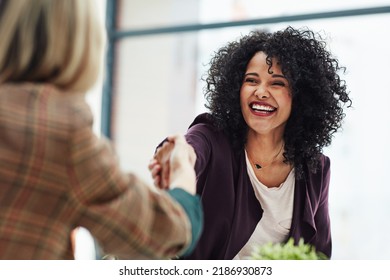 Handshake with a happy, confident and excited business woman or human resources manager and a female colleague, partner or employee. An agreement, deal or meeting with a coworker in the boardroom - Shutterstock ID 2186930873