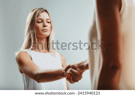 Handshake with hesitancy, a woman's expression reveals uncertainty, possibly concealing apprehensive thoughts